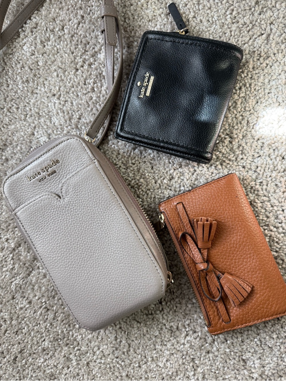 kate spade gray crossbody with black zip wallet and brown tassel cardholder